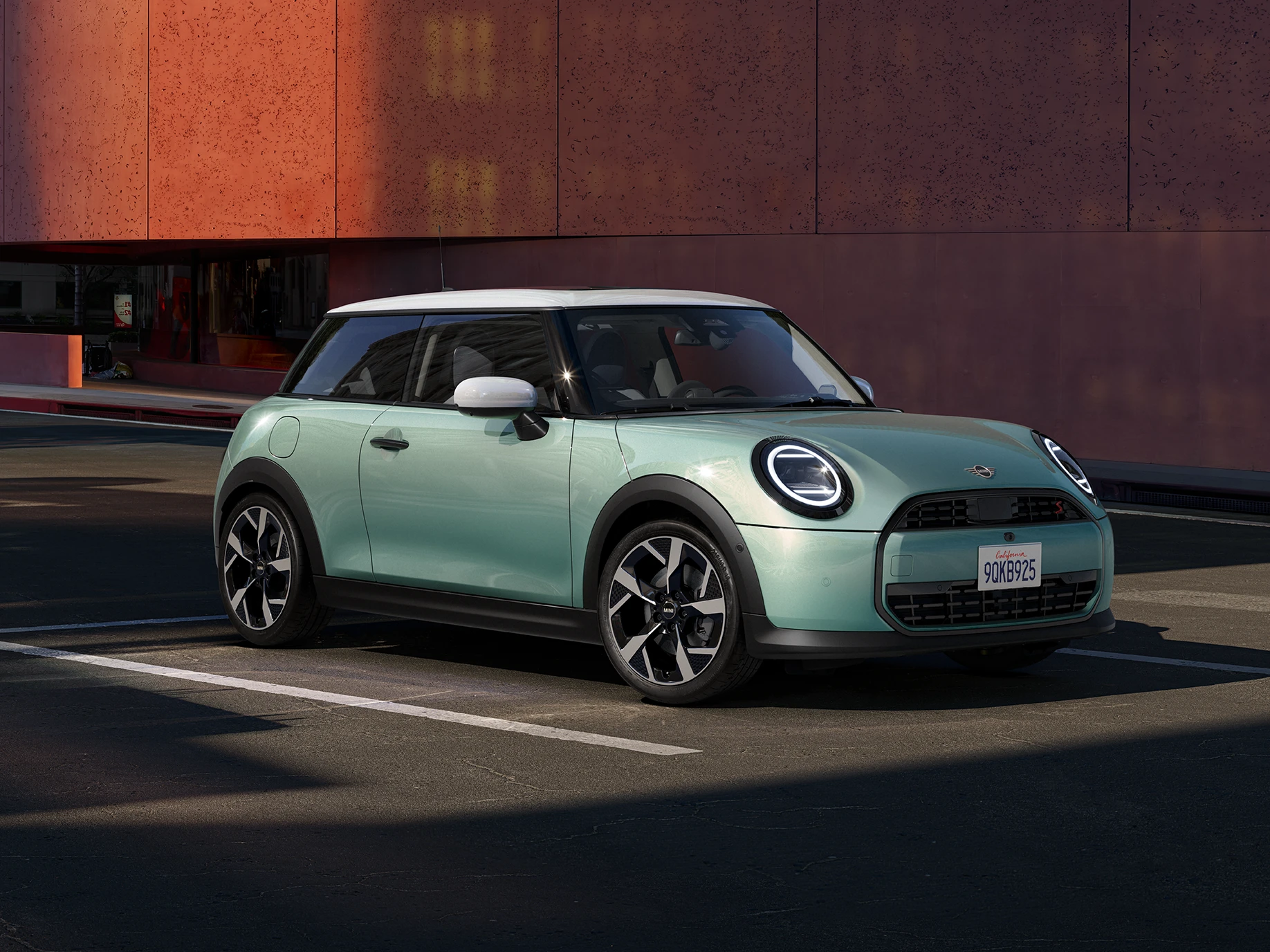 Side front view of the MINI Cooper in Ocean Wave Green and White Roof.