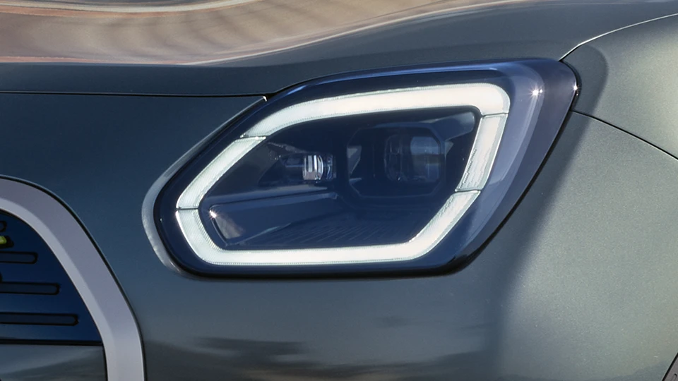 Close‑up of the LED headlight on a MINI Countryman in Slate Grey Metallic.